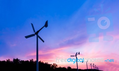 Wind Turbine On Sunset Twilight Time Stock Photo