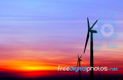 Wind Turbine Silhouette On Colorful Sunset Stock Photo