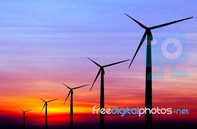 Wind Turbine Silhouette On Colorful Sunset Stock Photo