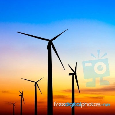 Wind Turbine Silhouette On Colorful Sunset Stock Photo