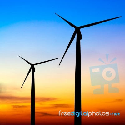 Wind Turbine Silhouette On Colorful Sunset Stock Photo