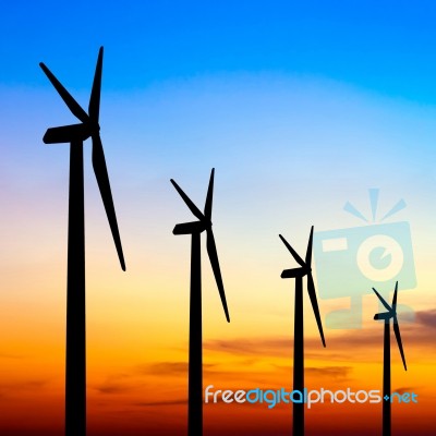 Wind Turbine Silhouette On Colorful Sunset Stock Photo