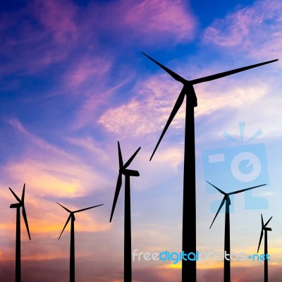 Wind Turbine Silhouette On Colorful Sunset Stock Photo