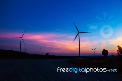 Wind Turbine With The Silhouette At Sky Stock Photo