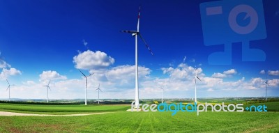 Wind Turbines On Blue Sky Background Stock Photo