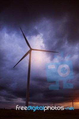 Wind Turbines With A Dark Sky Stock Photo