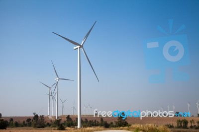 Windmill In Wind Farm With Blue Sky Stock Photo