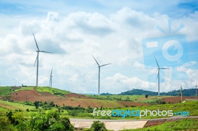 Windmills New Energy With Spring Flower On The Mountain Stock Photo