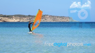 Windsurfer Enjoying A Summer Day In A Mediterranean See Stock Photo