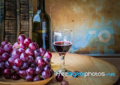 Wine And Grapes On A Wooden Stock Photo