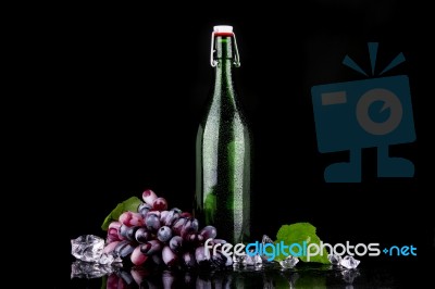 Wine Bottle With Red Grape Stock Photo