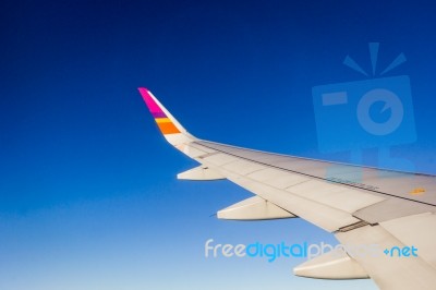 Wing Of The Plane On Blue Sky Background Stock Photo