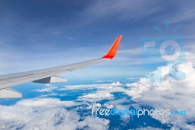 Wing Of The Plane With Blue Sky And Clouds Stock Photo