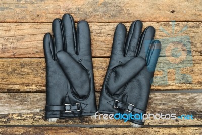 Winter Black Leather Gloves With Fur On Wooden Table Stock Photo