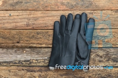 Winter Black Leather Gloves With Fur On Wooden Table Stock Photo