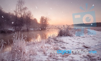 Winter Misty Dawn On The River. Snowflakes, Snowfall. Sunny Wint… Stock Photo