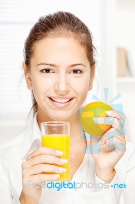 Woman And Fresh Orange Juice Stock Photo