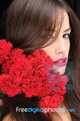 Woman And Red Carnations Stock Photo