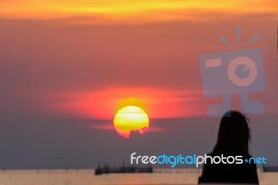 Woman And The Sunset Stock Photo