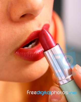 Woman Applying Lipstick Stock Photo