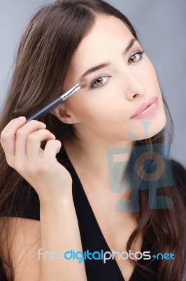 Woman Applying Make Up Stock Photo