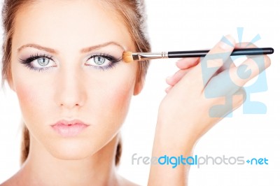 Woman Applying Make Up With Brush Stock Photo