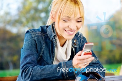 Woman At Park Taking A Phone Call Stock Photo