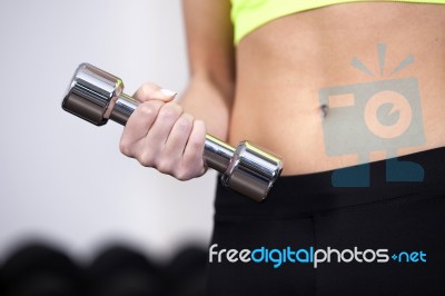 Woman At The Gym Lifting Free Weights Stock Photo