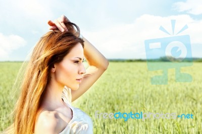 Woman At Wheat Field On Sunny Day Stock Photo