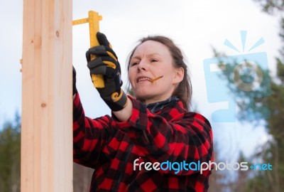 Woman Measuring On A Construction Stock Photo