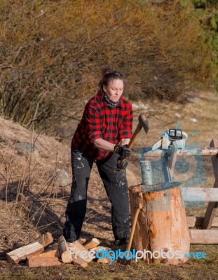 Woman Working With An Axe Stock Photo