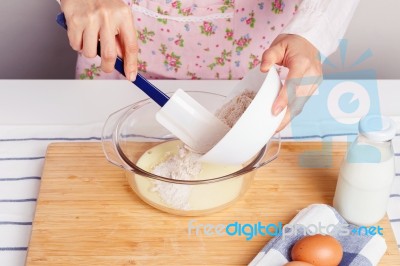 Woman Baking And Mixing Flour With Milk Stock Photo