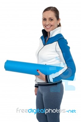 Woman Carrying Blue Yoga Mat Stock Photo