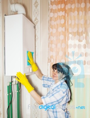 Woman Cleaning A Boiler With A Rag Stock Photo