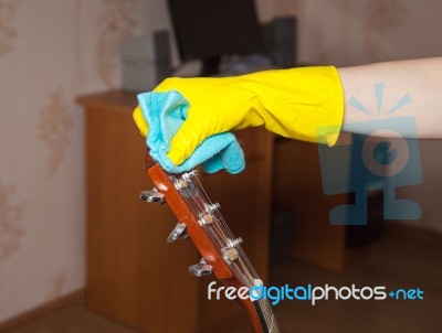 Woman Cleaning A Guitar With A Rag Stock Photo