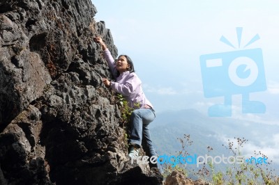 Woman Climbing Rock Stock Photo