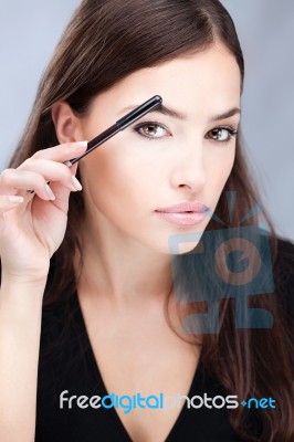 Woman Combing Eyebrow Stock Photo