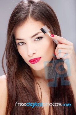 Woman Combing Eyebrow Stock Photo