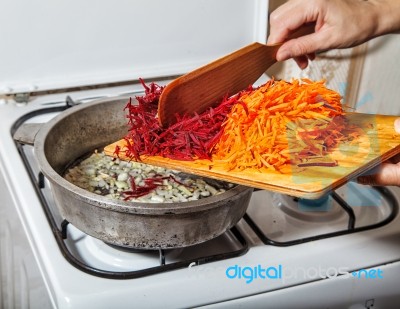 Woman Cooks Carrots And Beets Stock Photo