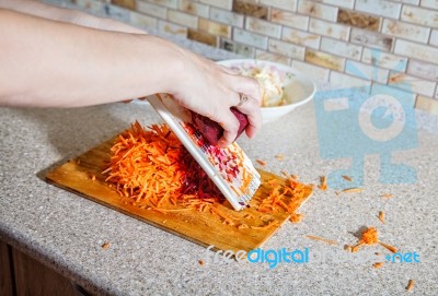 Woman Cooks The Beets On A Grater Stock Photo