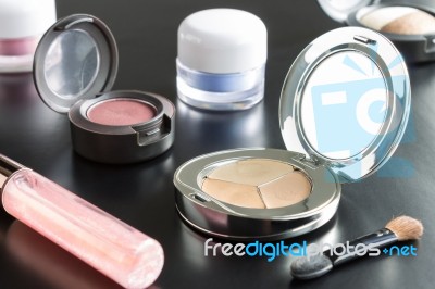 Woman Cosmetic Foundation And Eyeshadow And Lip Gloss And Brush Stock Photo