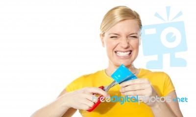 Woman Cutting Her Credit Card Stock Photo