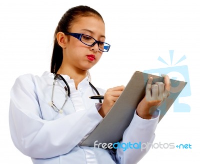 Woman Doctor Writing A Report Stock Photo