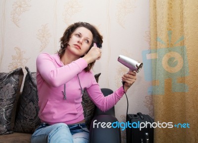 Woman Dries The Hair Dryer Stock Photo