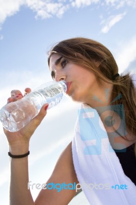 Woman Drinking Water After Sport Activities Stock Photo