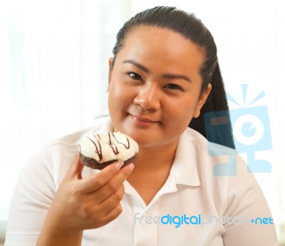 Woman Eating A Donut Stock Photo