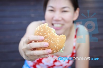 Woman Eating A Hamburger Stock Photo