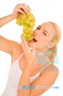 Woman Eating Grapes Stock Photo