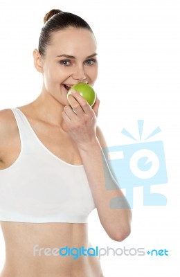 Woman Eating Green Apple Stock Photo