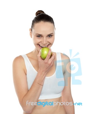 Woman Eating Green Apple Stock Photo